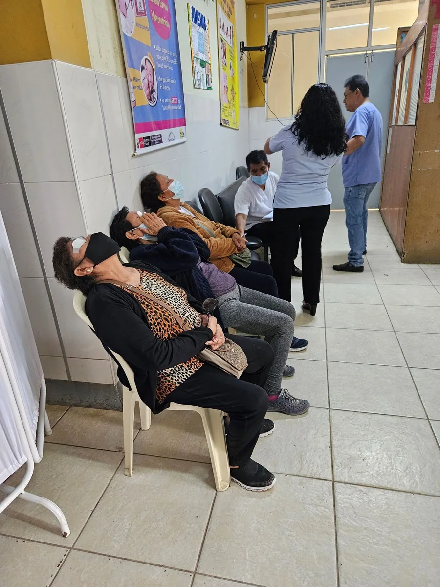 Patients receive eye drops while waiting for an examination.