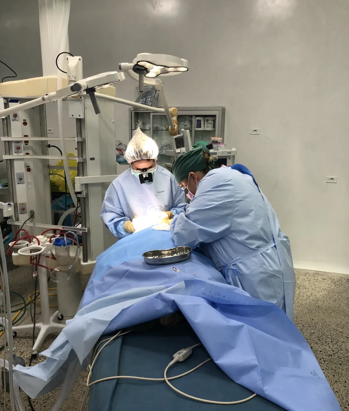 Two clinicians work together during an eye surgery.